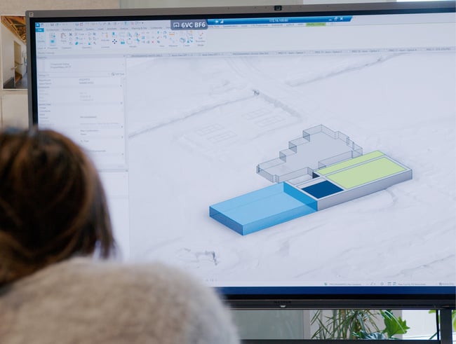 designers looking at a BIM model on a smartboard