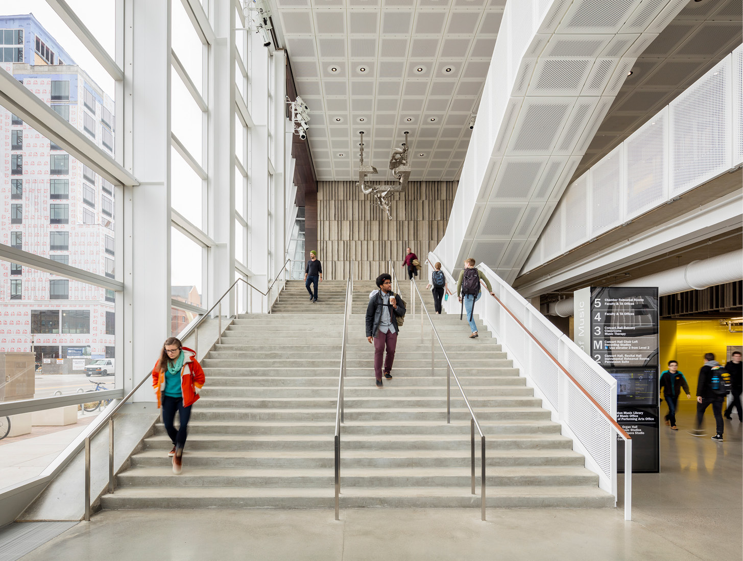 students walking down stairs in a LEED certified building