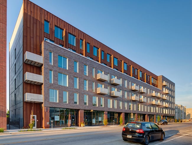 a multifamily building made with brick and Corten steel