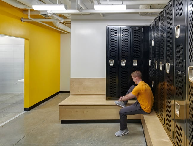a locker room at Lone Tree Wellness Center with a yellow wall
