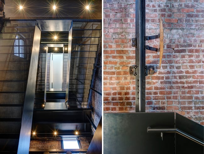 perforated metal staircase at Market One, pulled back from the wall to reveal the former freight elevator rails