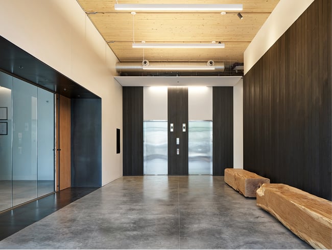 a building lobby featuring hardwood ceiling finishes