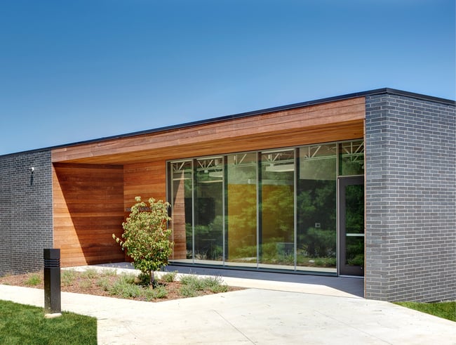 Exterior of Pella Career Center with brick and wood slat siding