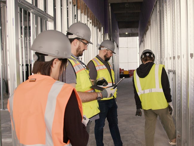 architect and contractor touring a building site